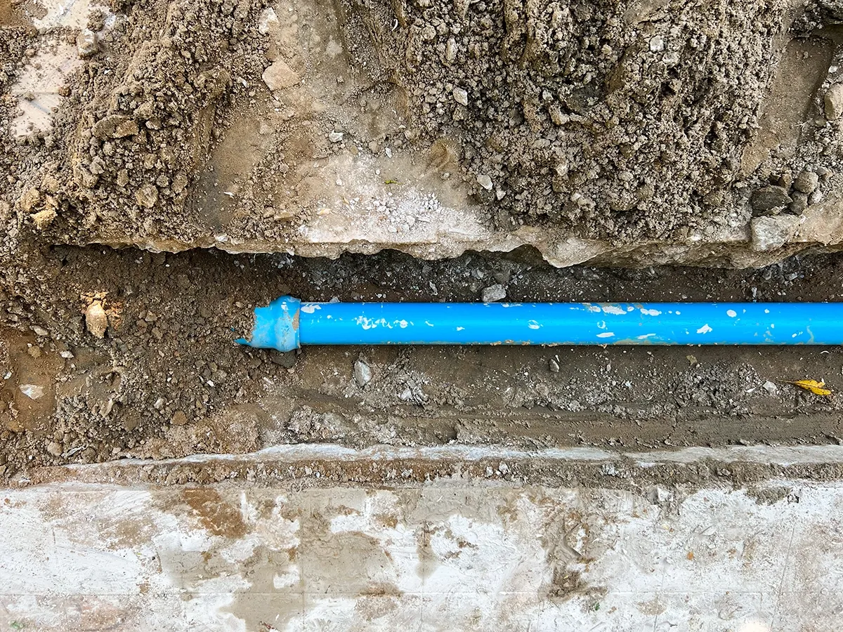 Exposed underground pipe during average cost to replace main water line project
