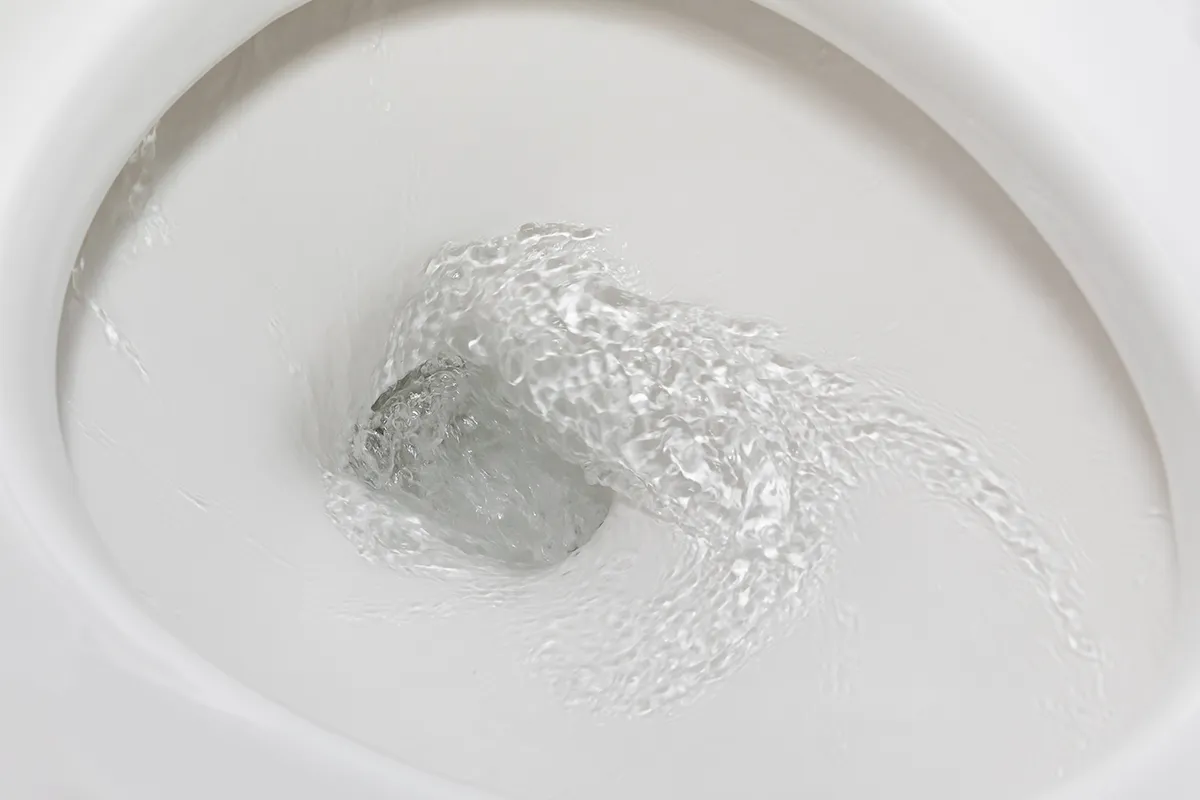 Toilet bowl water level dropping overnight in Marshville with water swirling during a flush.