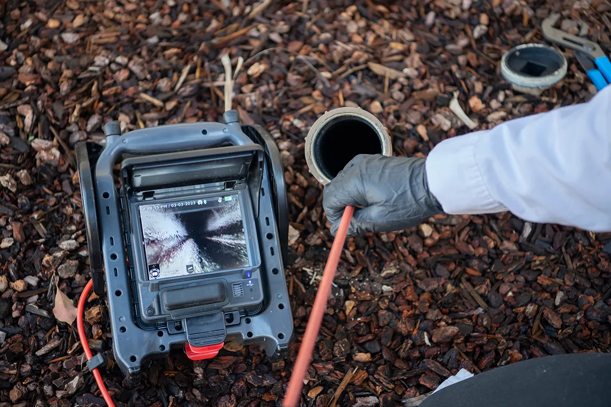 Technician inspecting a sewer line with a camera for a guide explaining what is pipe relining.