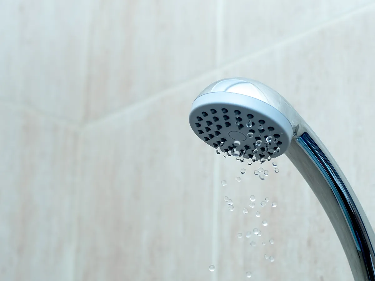 Weak shower flow showing when to call a plumber for low water pressure.