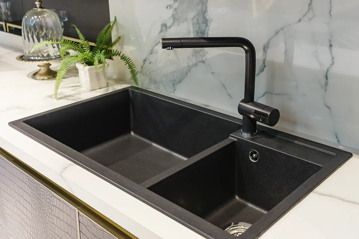 Black double-bowl sink with modern faucet featured in a kitchen sink installation cost Gastonia guide.