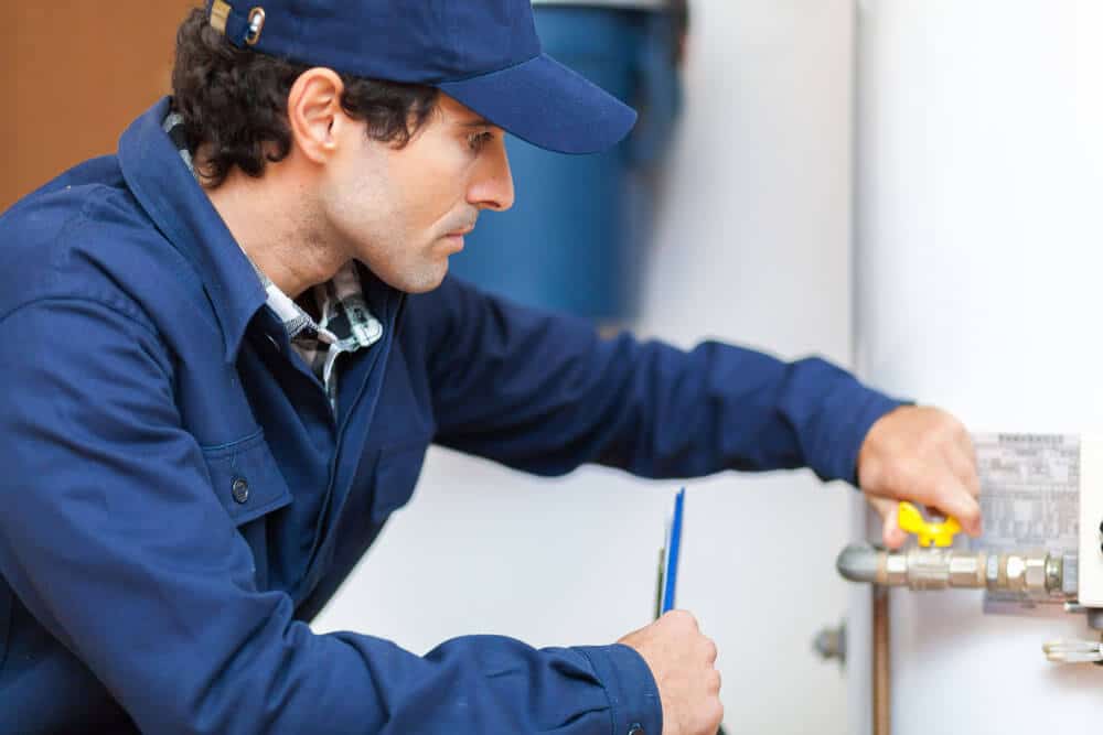 Plumbing Technician Inspecting Water Heater